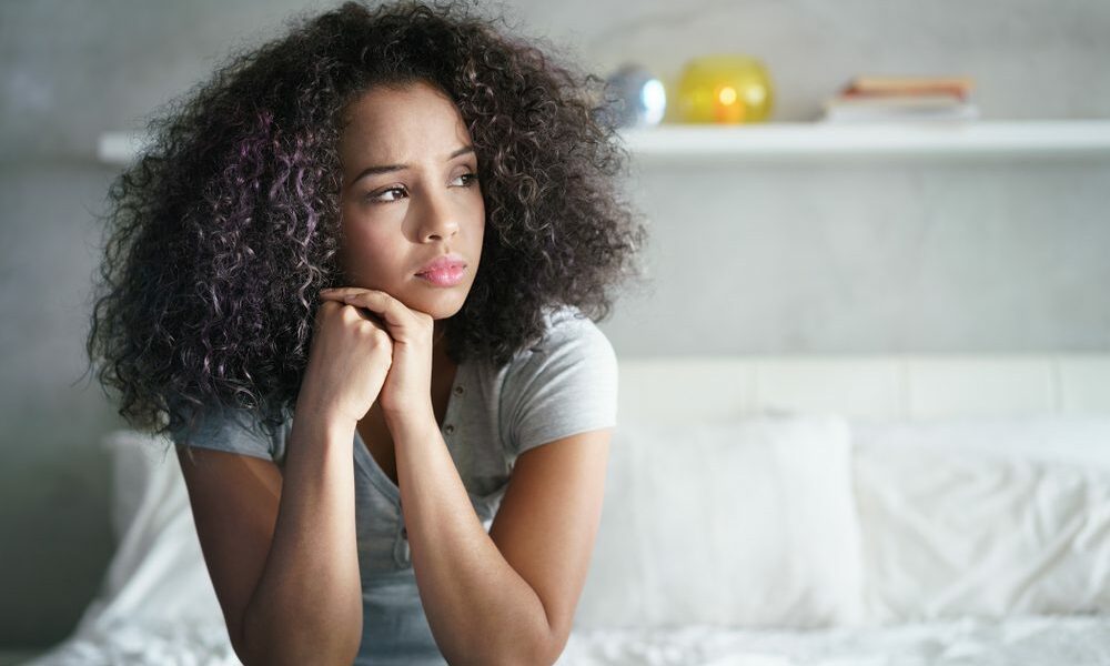 Lonely,Young,Latina,Woman,Sitting,On,Bed.,Depressed,Hispanic,Girl